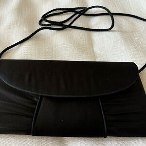 Black satin clutch. Used it for one event. Perfect condition.